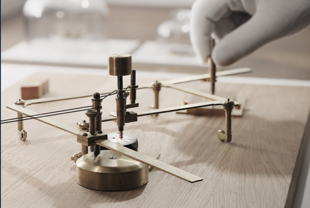 Close-up of a precision engraving machine in use on a wooden workbench