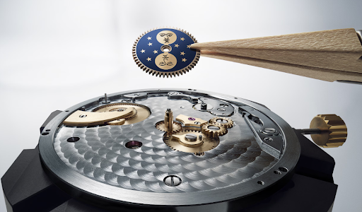 Watchmaker's tweezers placing a blue moon-phase disc with engraved moon faces onto a Breguet Classique Phase de Lune 7235BH/0H/9V6