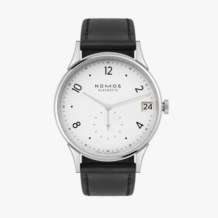 The Nomos Minimatik 39 Date Ref. 1250 featuring a silver-plated dial with a golden-framed date aperture at 3 o’clock.