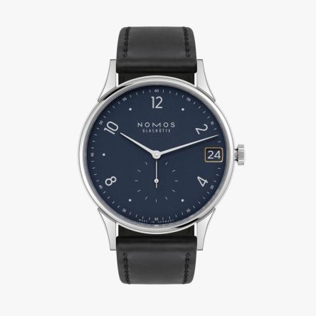 The Nomos Minimatik 39 Date Blue Ref. 1252 showcases a deep blue dial with golden accents and minimalist elegance.