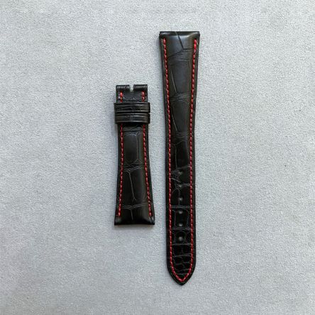 Matte black alligator strap with red stitching, square scales, deployment clasp, long length