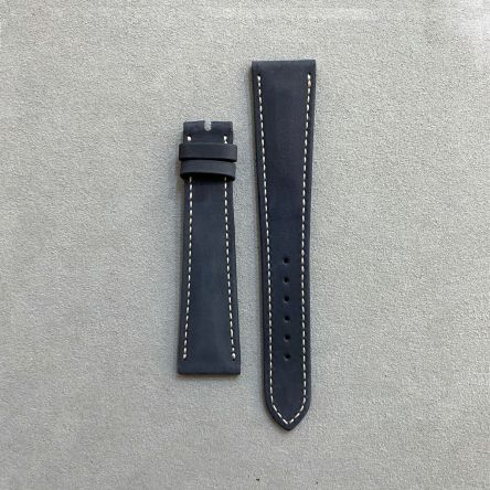 Navy blue suede calf strap with off-white stitching, pin buckle, long length