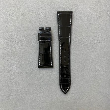 Shiny black alligator strap with white stitching, square scales, deployment clasp, short length