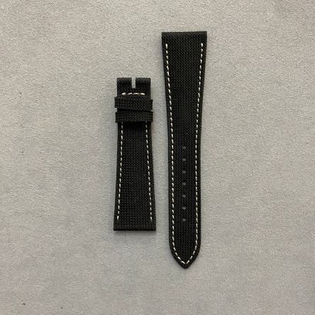 Black composite strap with off-white stitching, fabric pattern, three-blade deployment clasp, regular length