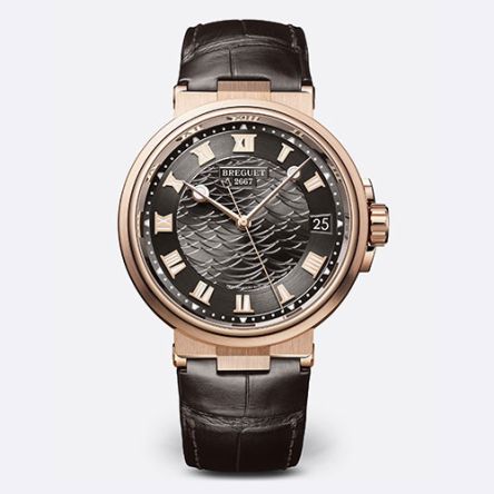 Breguet Marine Ref. 5517BR featuring a silver wave-pattern guilloché dial with Roman numerals, blued open-tipped hands, and a brown leather strap.